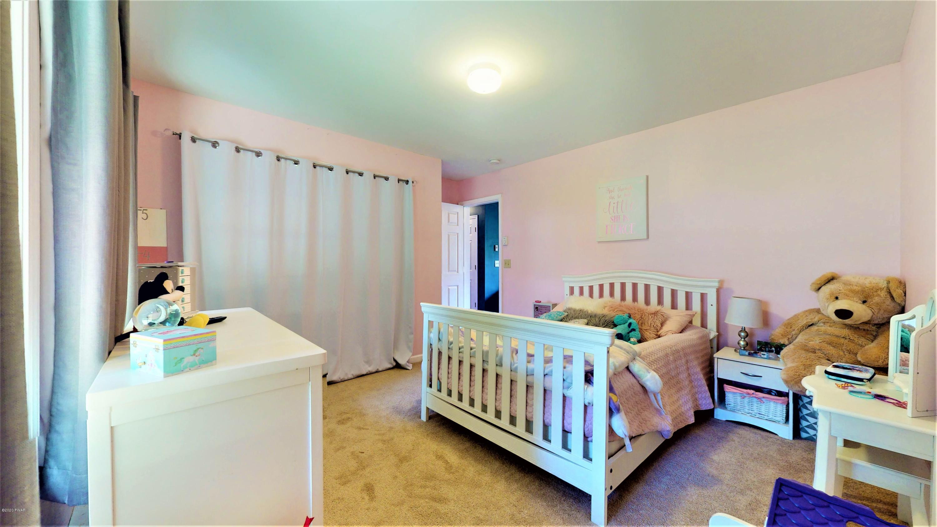 143 Raccoon Road Dingmans Ferry, PA 18328 - Photo 83 of 87 a bedroom with a bed and a window