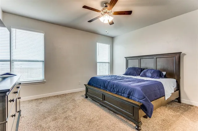 a spacious bedroom with a bed and window