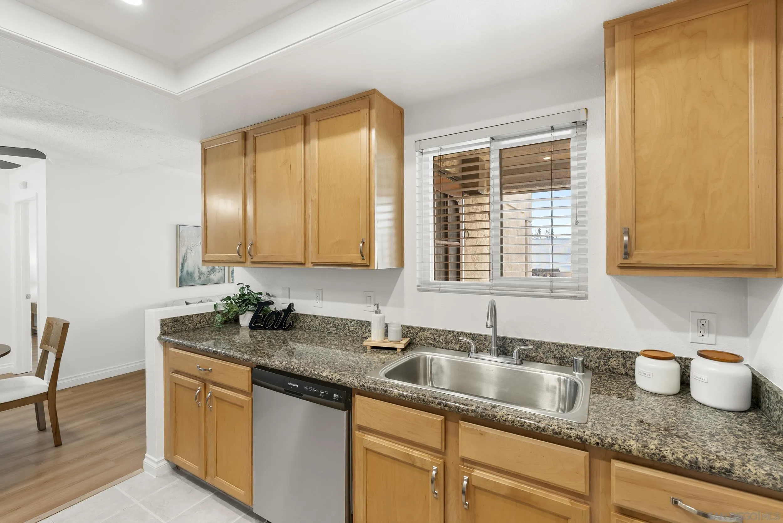 830 Broadway, Unit 15 El Cajon, CA 92021 - Photo 12 of 21 a kitchen with granite countertop kitchen island a sink a window and stainless steel appliances