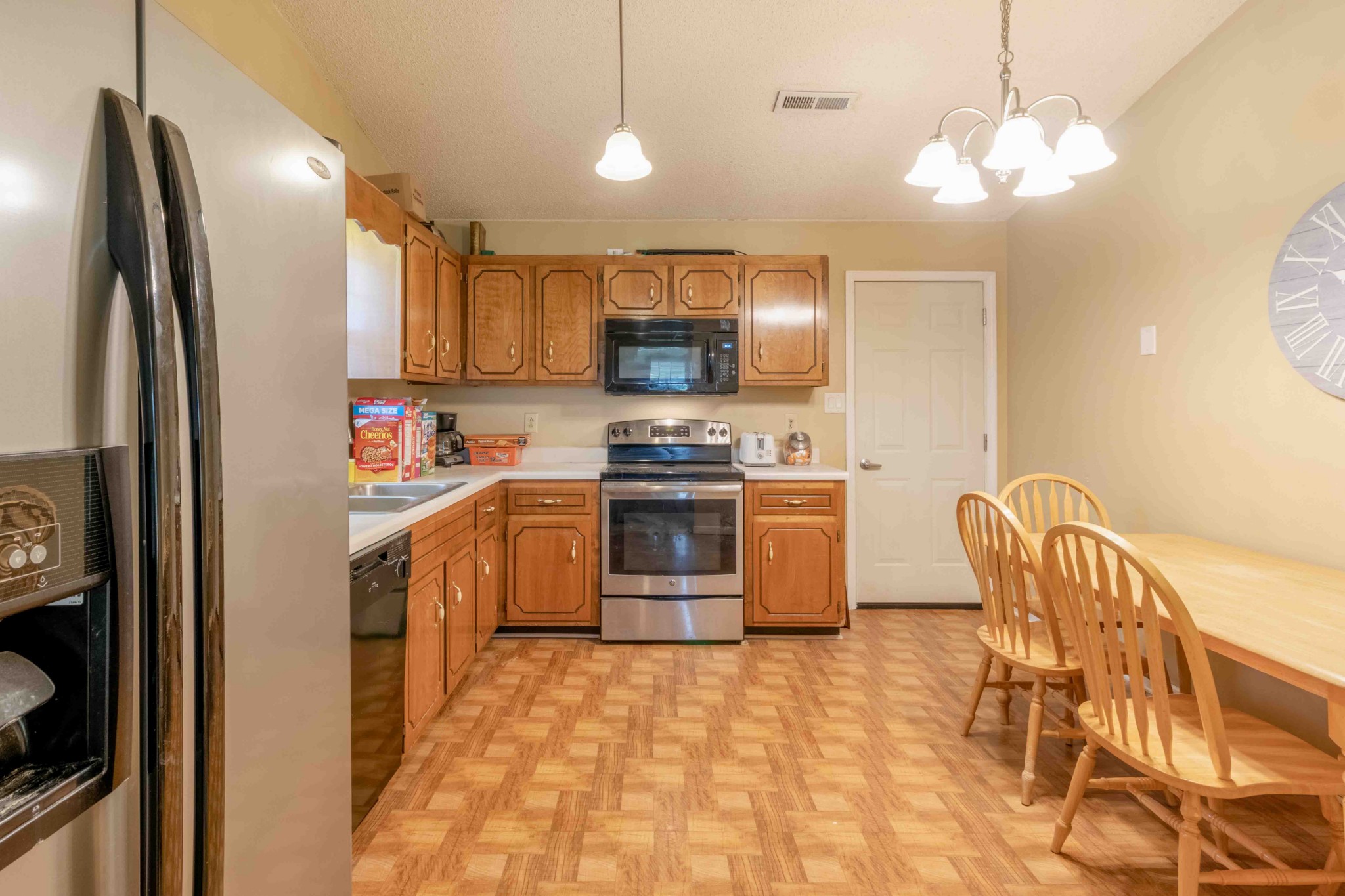 145 Bumpus Mill Road Oak Grove, KY 42262 - Photo 11 of 31 a kitchen with stainless steel appliances granite countertop a refrigerator a stove a sink and a dining table with wooden floor