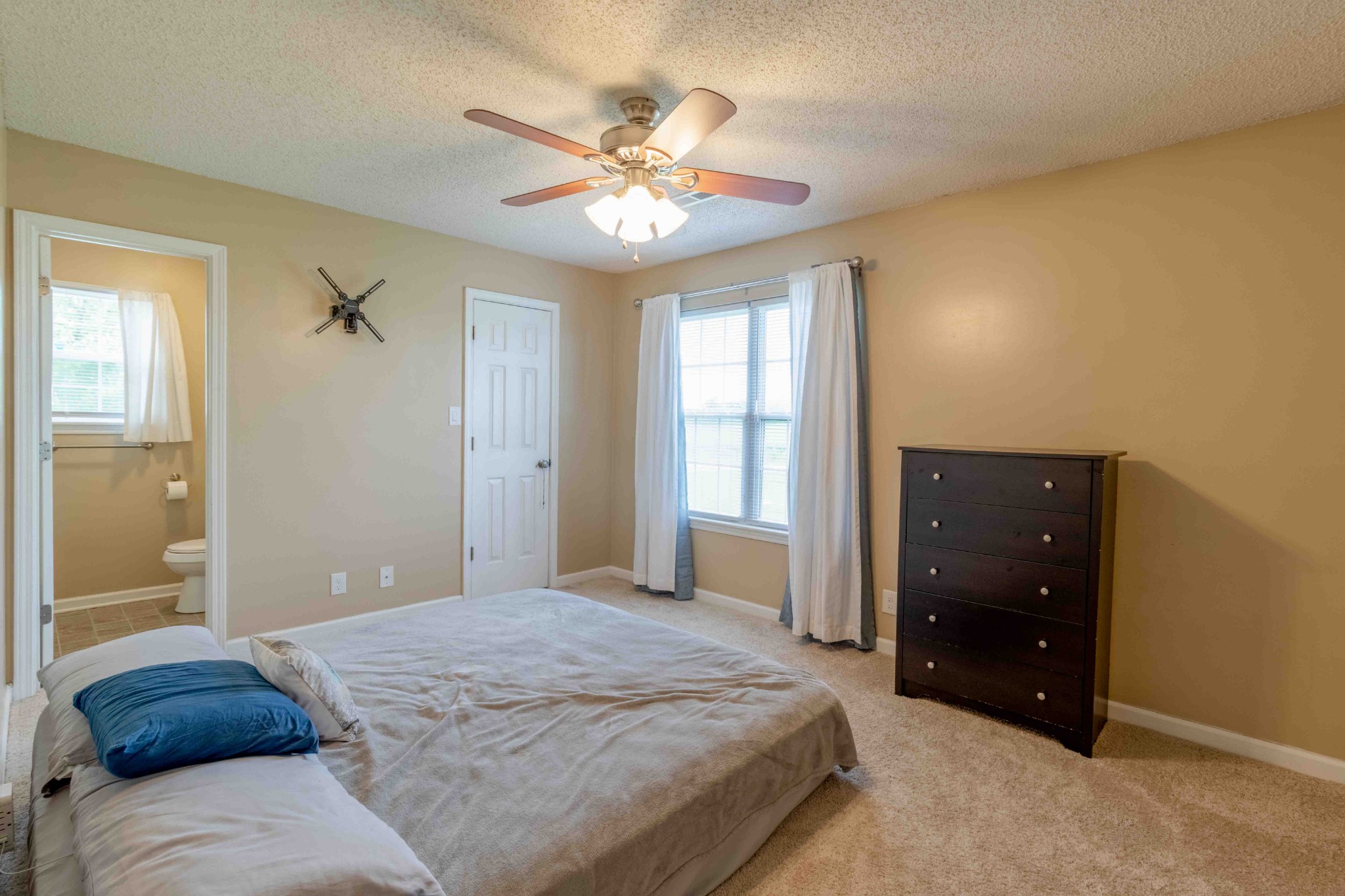 145 Bumpus Mill Road Oak Grove, KY 42262 - Photo 15 of 31 a bedroom with a large bed and a chandelier