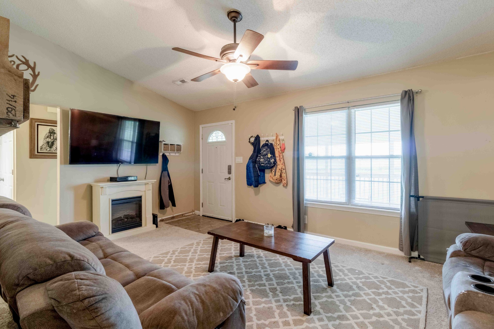 145 Bumpus Mill Road Oak Grove, KY 42262 - Photo 10 of 31 a living room with furniture a flat screen tv and a fireplace