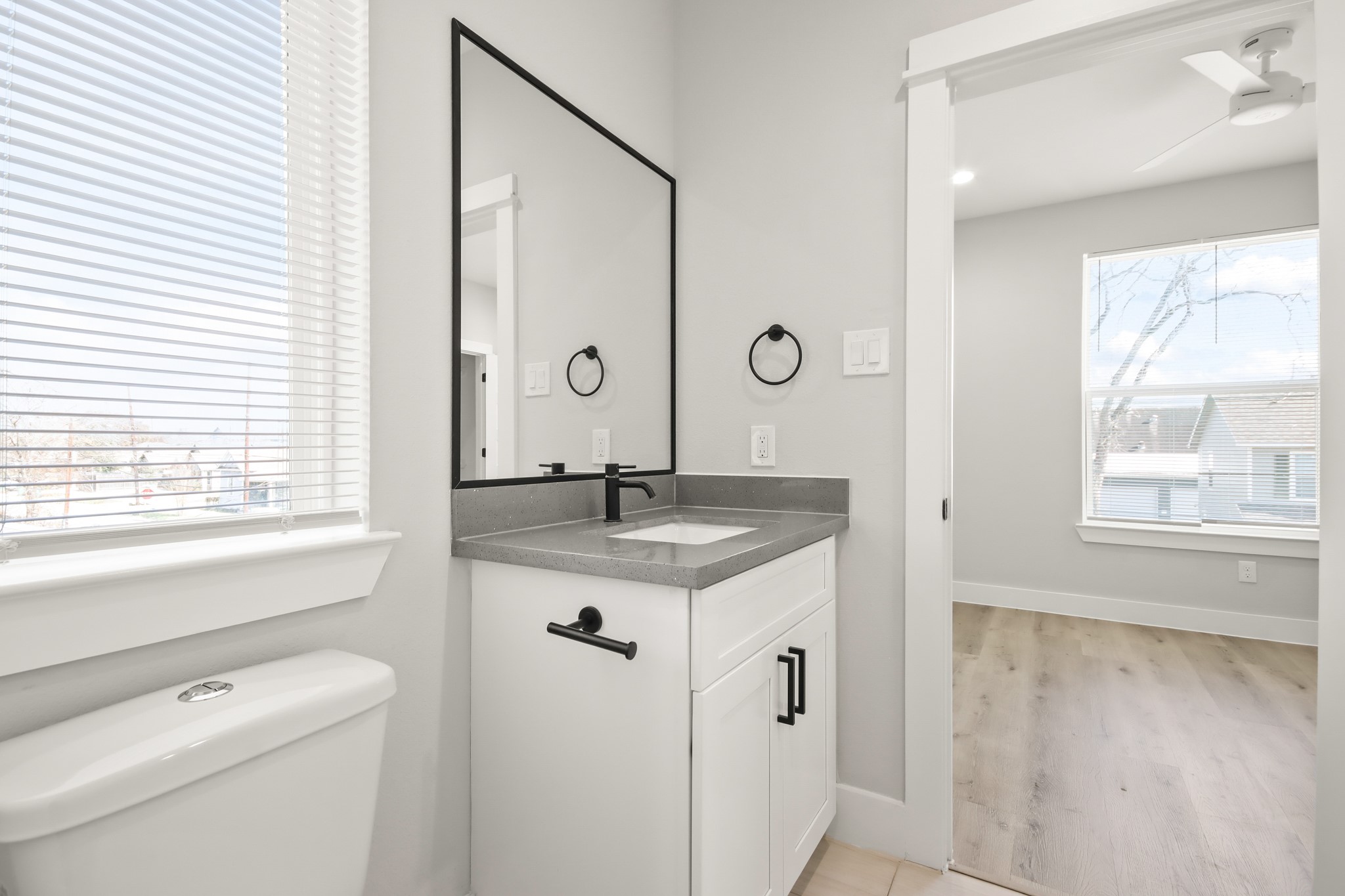 2105 Sam Wilson Street, Unit E Houston, TX 77020 - Photo 13 of 30 a bathroom with a granite countertop sink a mirror a and a window