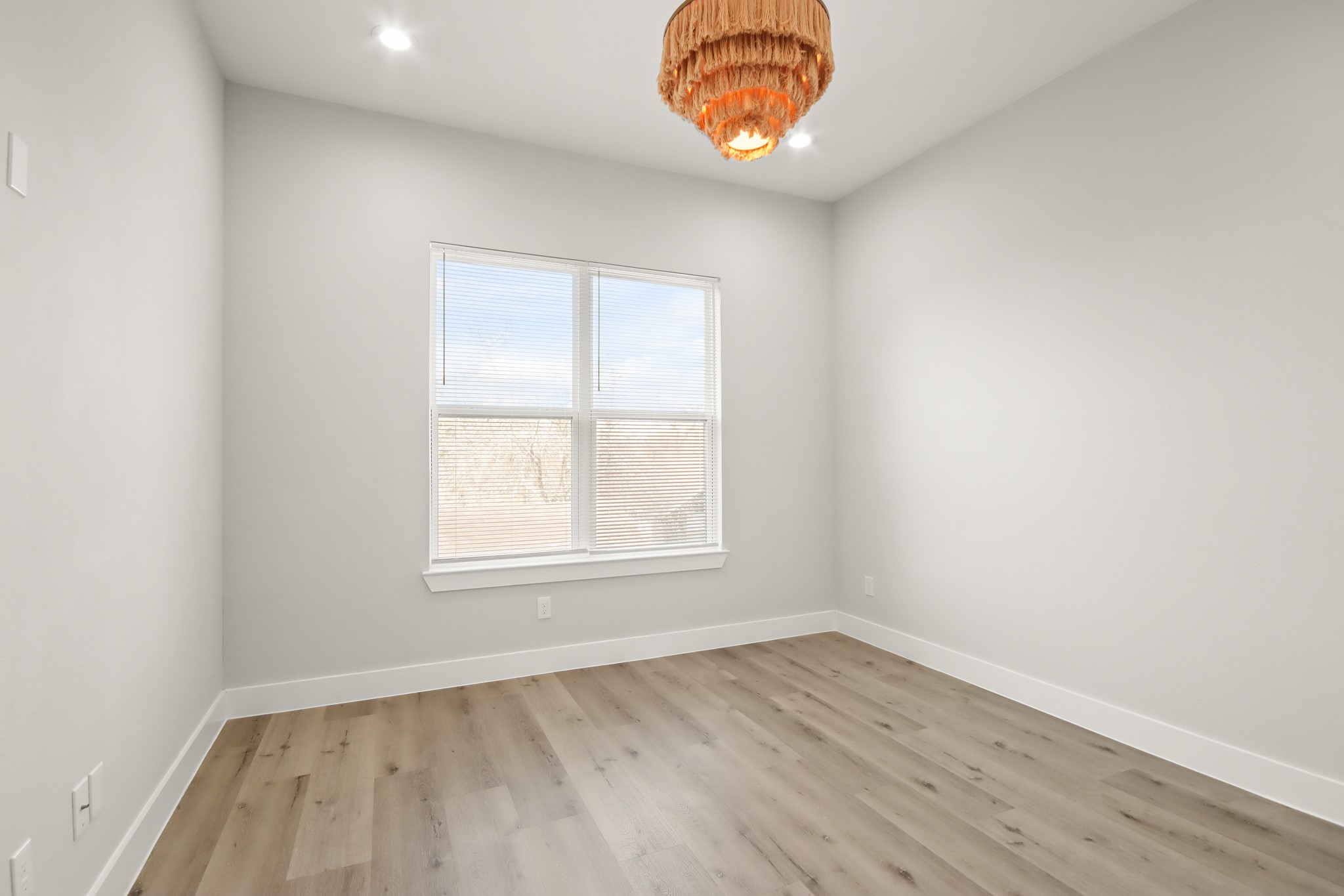 2105 Sam Wilson Street, Unit E Houston, TX 77020 - Photo 18 of 30 an empty room with wooden floor and windows