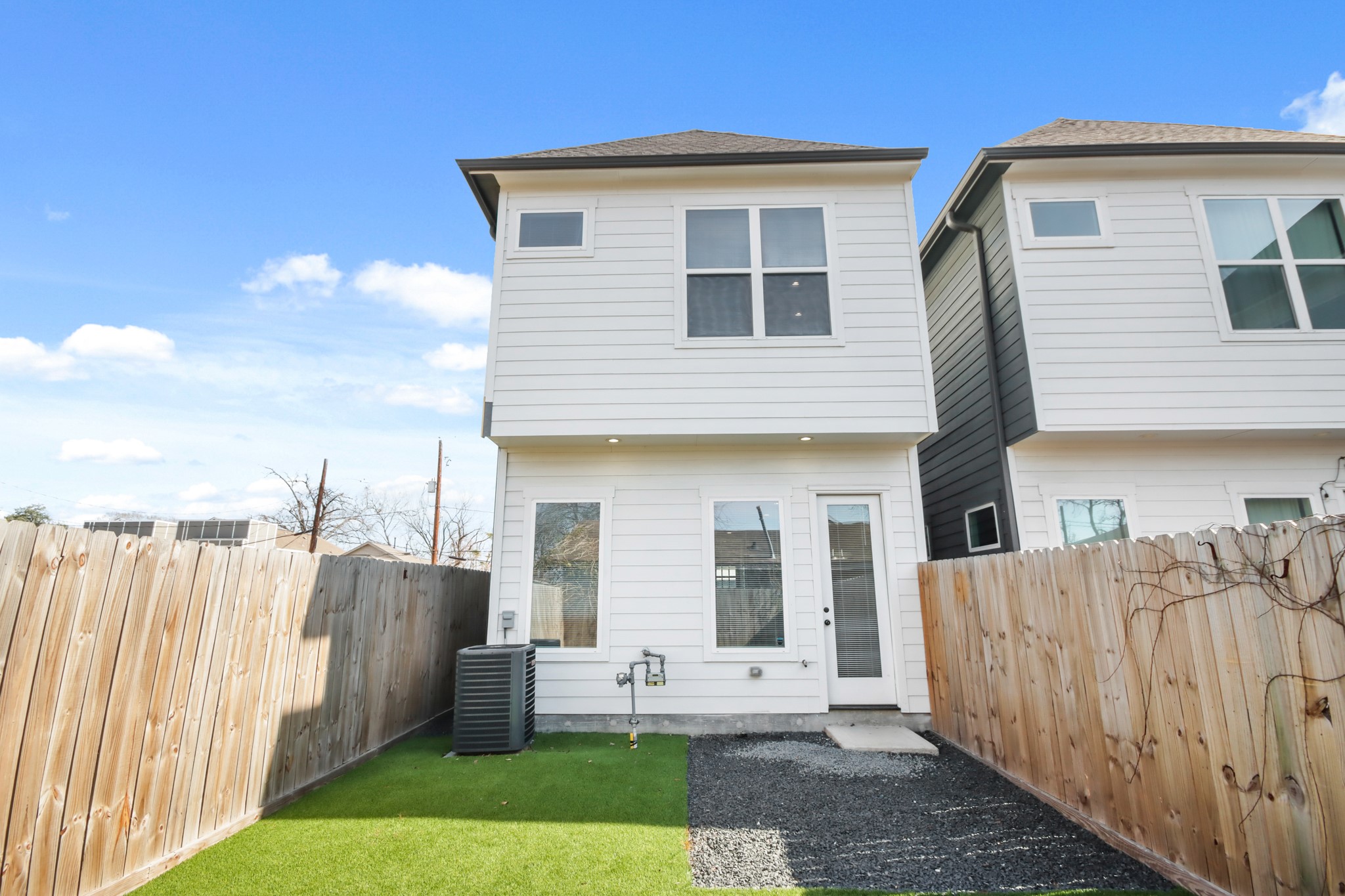 2105 Sam Wilson Street, Unit E Houston, TX 77020 - Photo 22 of 30 a front view of a house with a yard