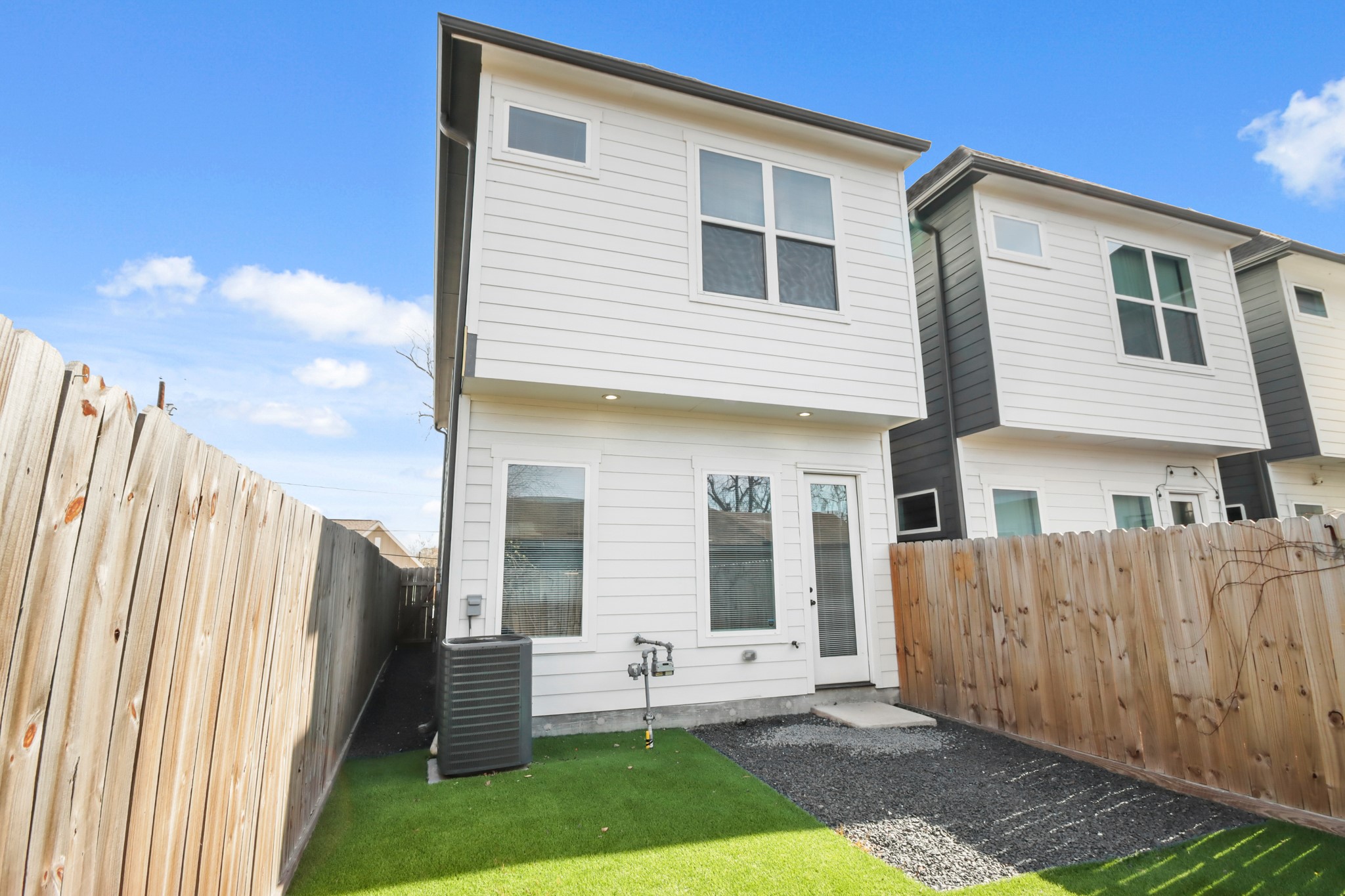 2105 Sam Wilson Street, Unit E Houston, TX 77020 - Photo 25 of 30 a view of a house with wooden floor and a yard
