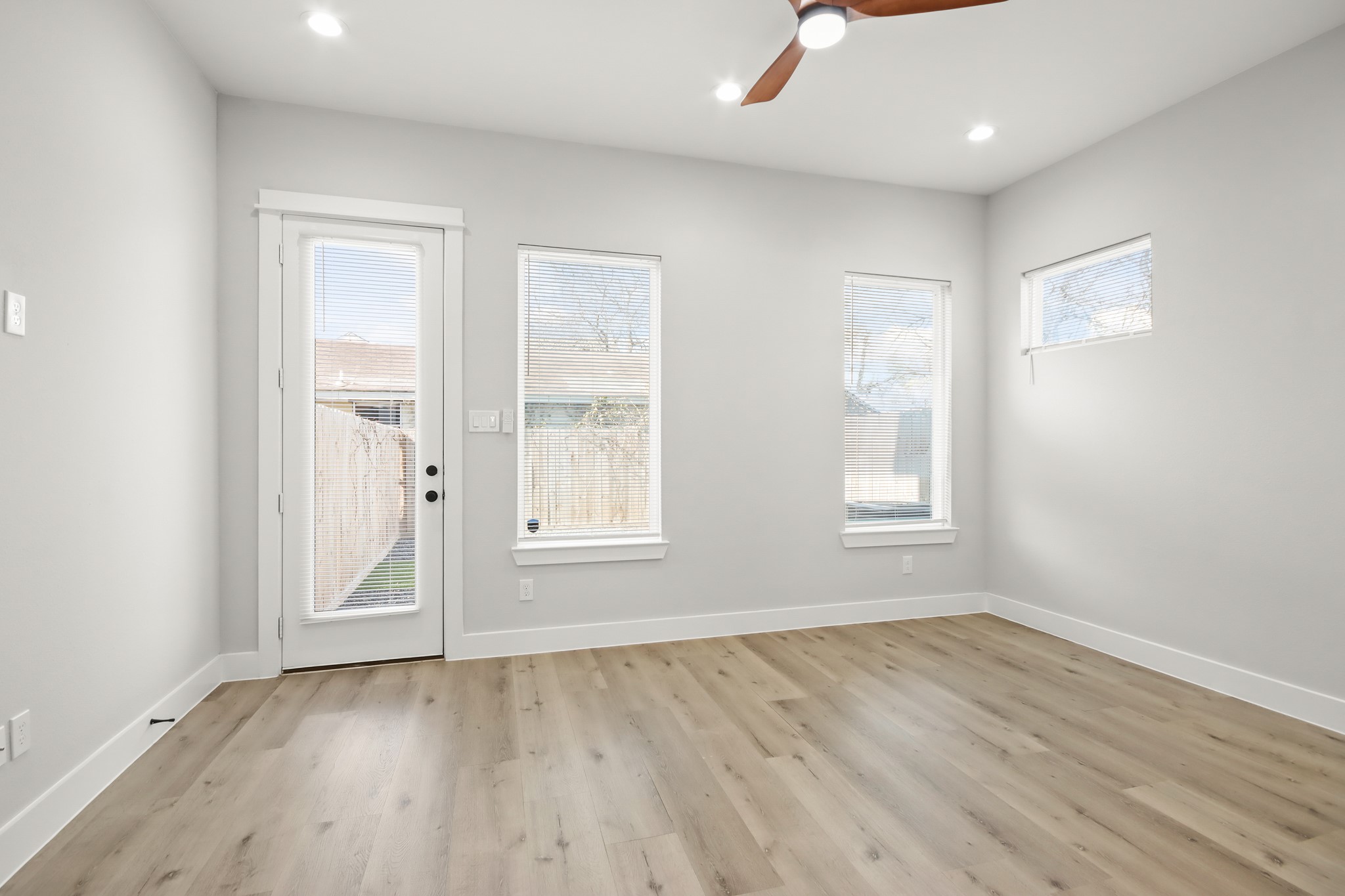 2105 Sam Wilson Street, Unit E Houston, TX 77020 - Photo 5 of 30 an empty room with wooden floor and windows
