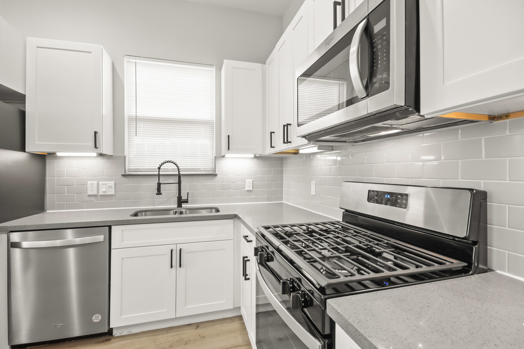 2105 Sam Wilson Street, Unit E Houston, TX 77020 - Photo 8 of 30 a kitchen with white cabinets a sink and appliances