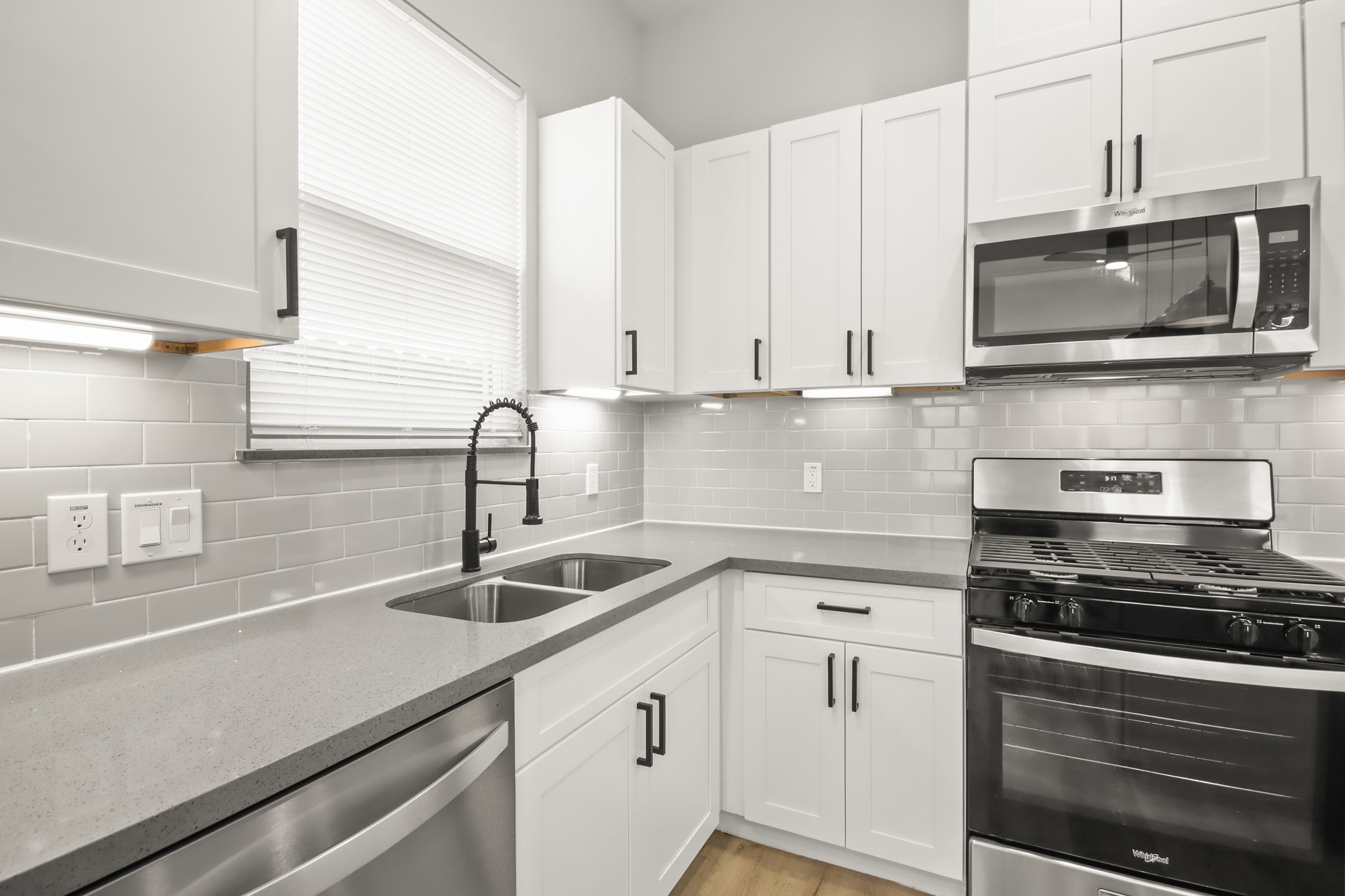 2105 Sam Wilson Street, Unit E Houston, TX 77020 - Photo 9 of 30 a kitchen with stainless steel appliances granite countertop white cabinets a sink and dishwasher