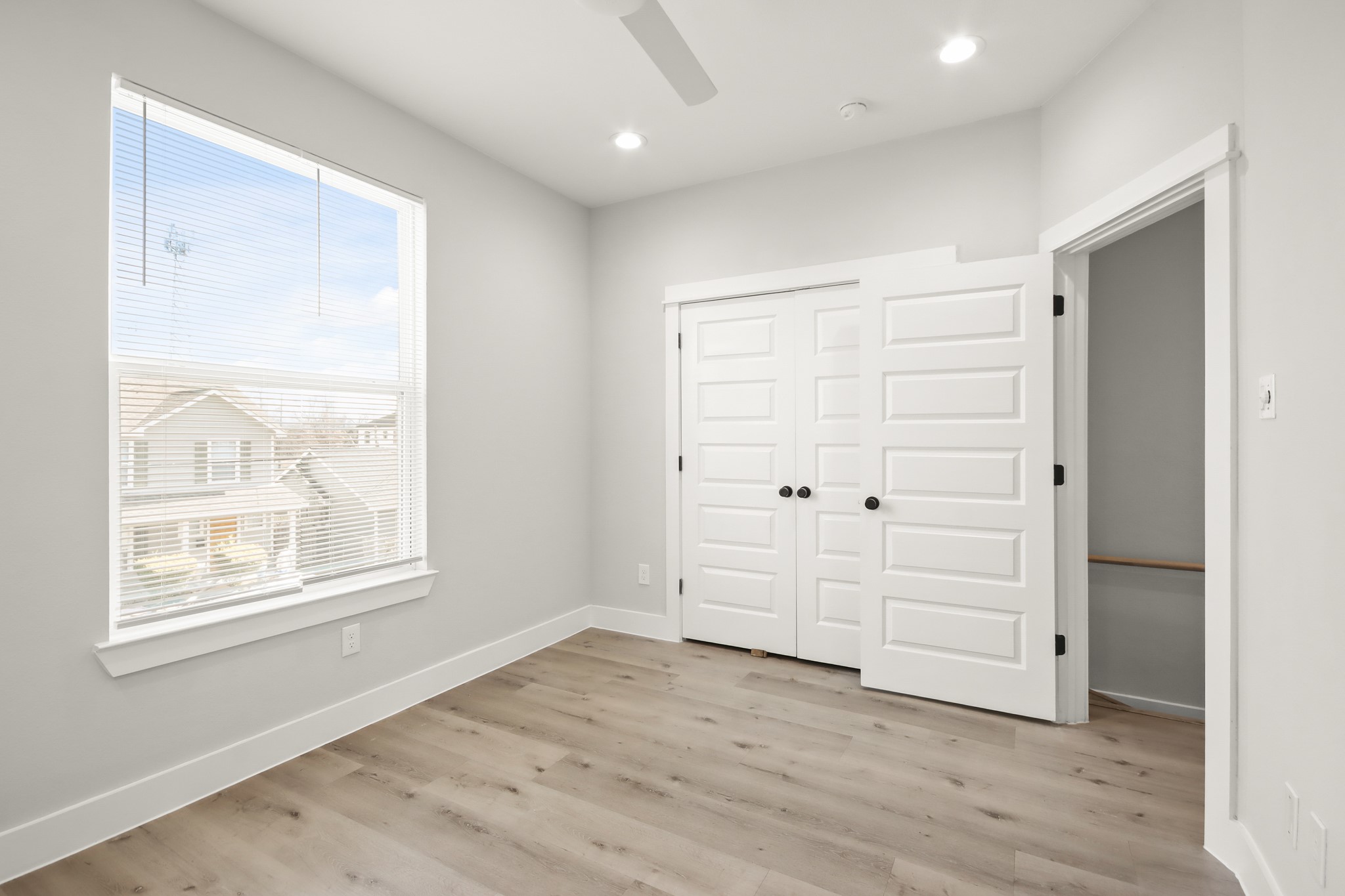 2105 Sam Wilson Street, Unit E Houston, TX 77020 - Photo 10 of 30 an empty room with wooden floor cabinet and windows