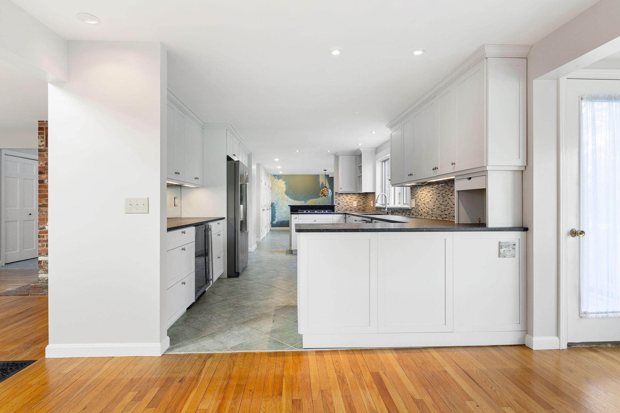 48 Namequoit Road Orleans, MA 02653 - Photo 21 of 97 a kitchen with stainless steel appliances granite countertop a refrigerator sink and white cabinets