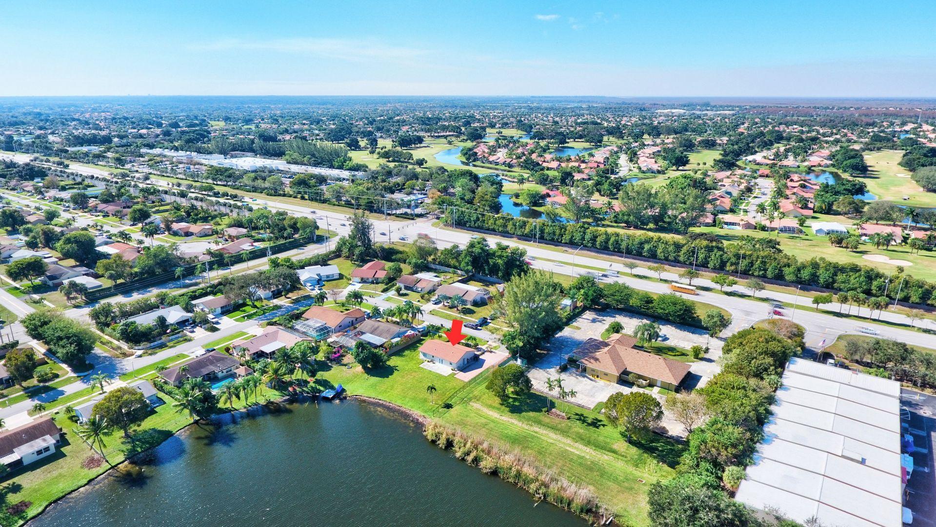 9989 Liberty Road Boca Raton, FL 33434 - Photo 37 of 44 an aerial view of a city with lots of residential buildings ocean and mountain view in back