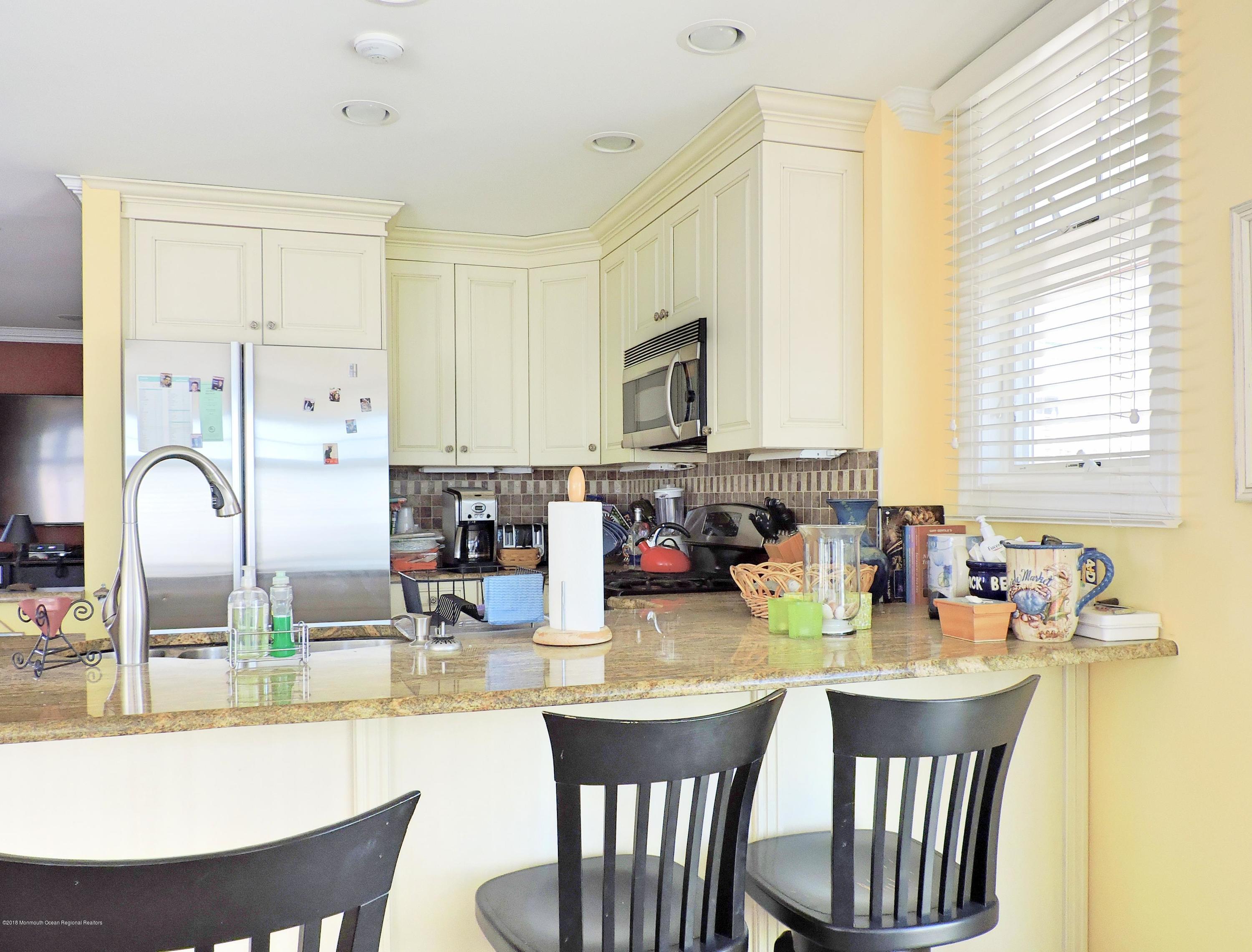 3436 Ocean Road Lavallette, NJ 08735 - Photo 4 of 24 a kitchen with a table chairs and microwave