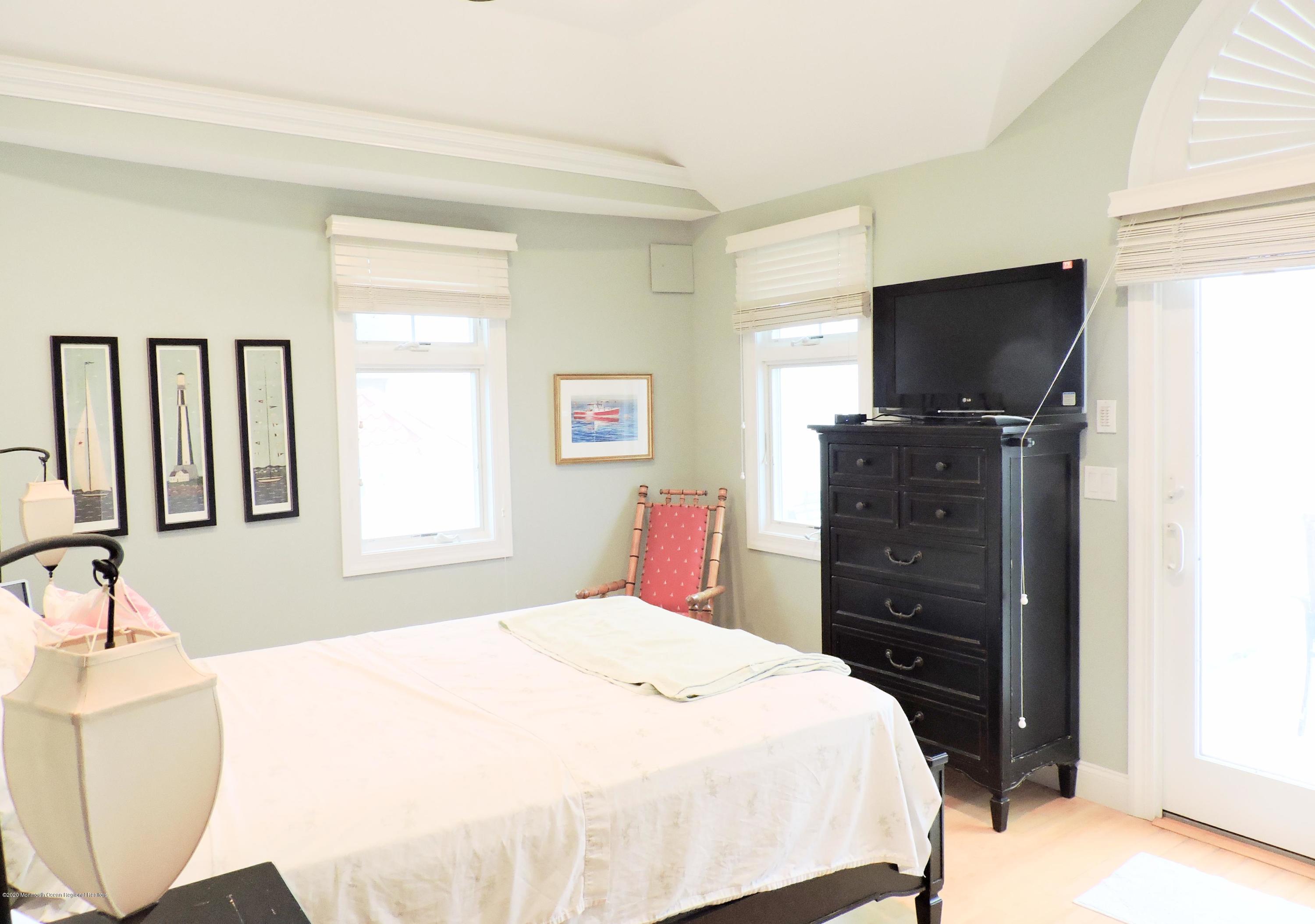 3436 Ocean Road Lavallette, NJ 08735 - Photo 8 of 24 a bedroom with a bed and a flat screen tv