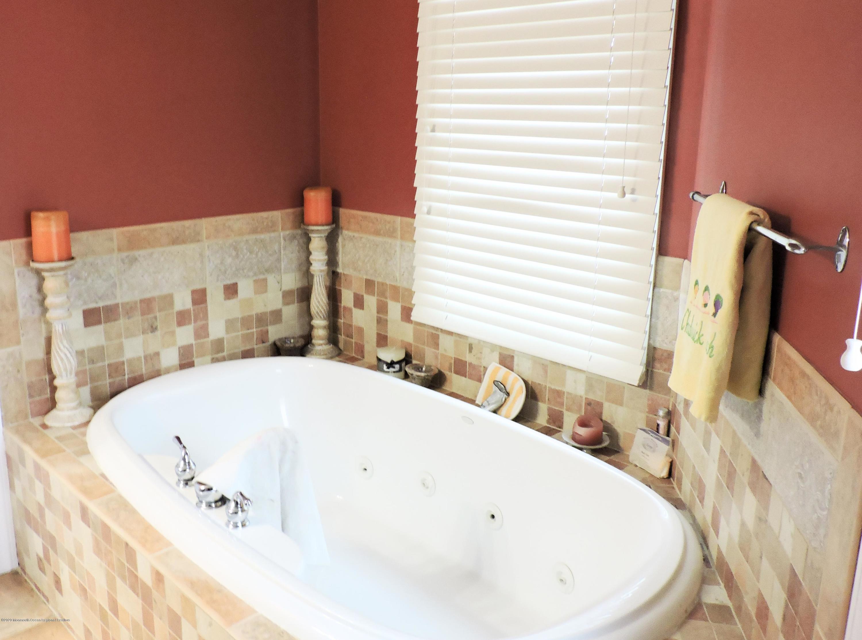 3436 Ocean Road Lavallette, NJ 08735 - Photo 10 of 24 a bathroom with a tub and a sink