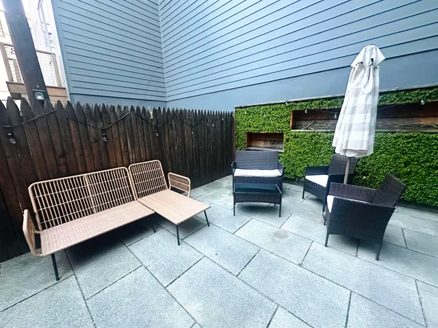a view of backyard with outdoor seating and a garden