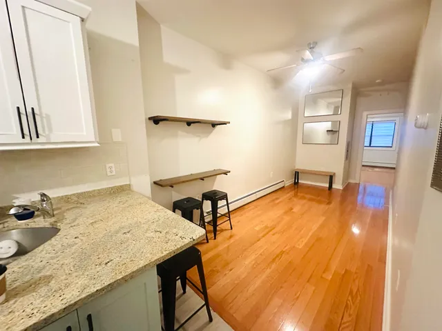 a room with sink and mirror