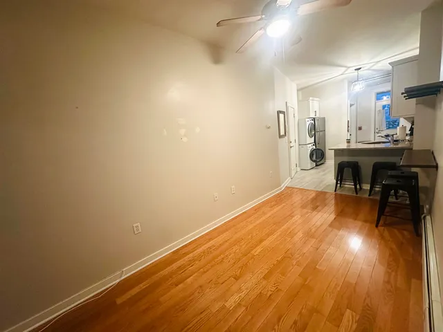 a view of a room with wooden floor and a sink