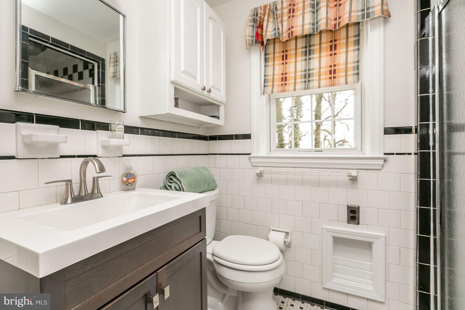 616 Hastings Road Baltimore, MD 21286 - Photo 13 of 23 a bathroom with a sink a toilet and a window