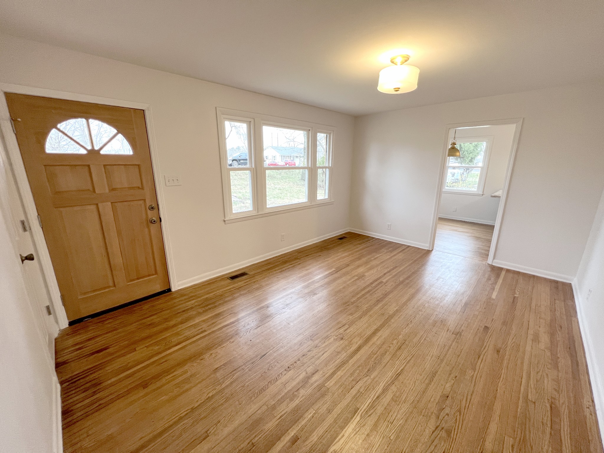 505 High Point Road Clarksville, TN 37042 - Photo 18 of 39 an empty room with wooden floor and a window