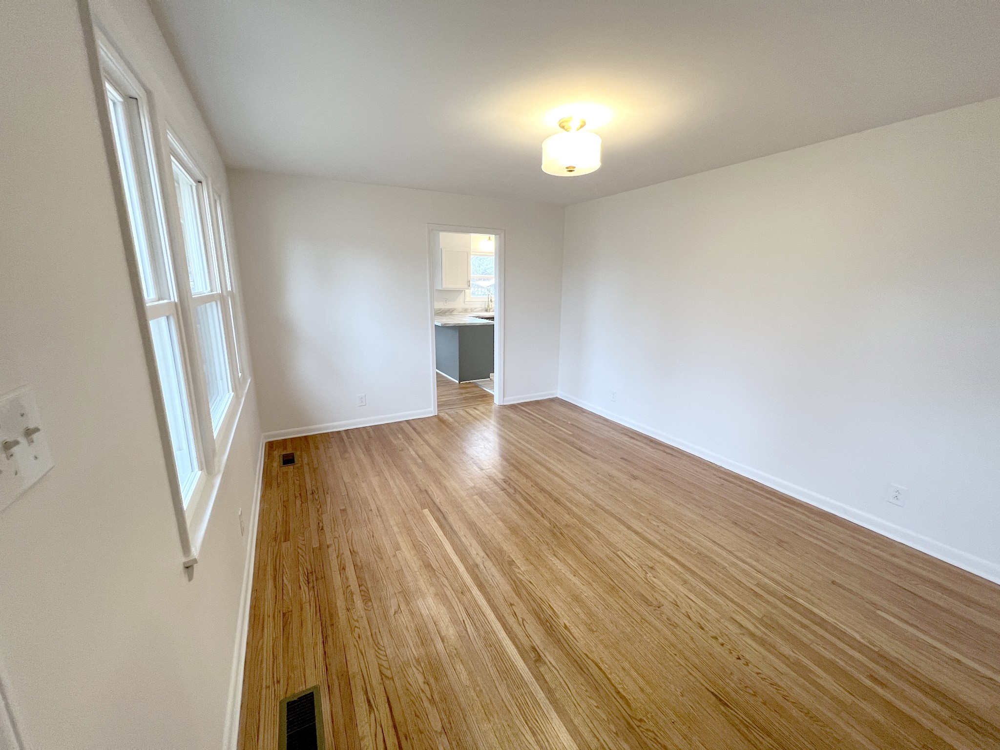 505 High Point Road Clarksville, TN 37042 - Photo 20 of 39 an empty room with wooden floor and windows