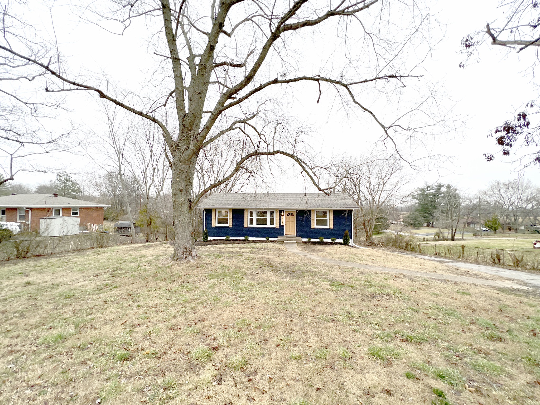 505 High Point Road Clarksville, TN 37042 - Photo 2 of 39 a view of large house with a big yard and large trees