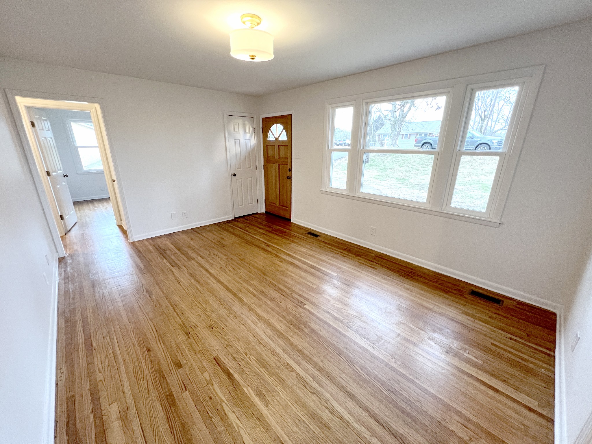 505 High Point Road Clarksville, TN 37042 - Photo 21 of 39 an empty room with wooden floor and windows