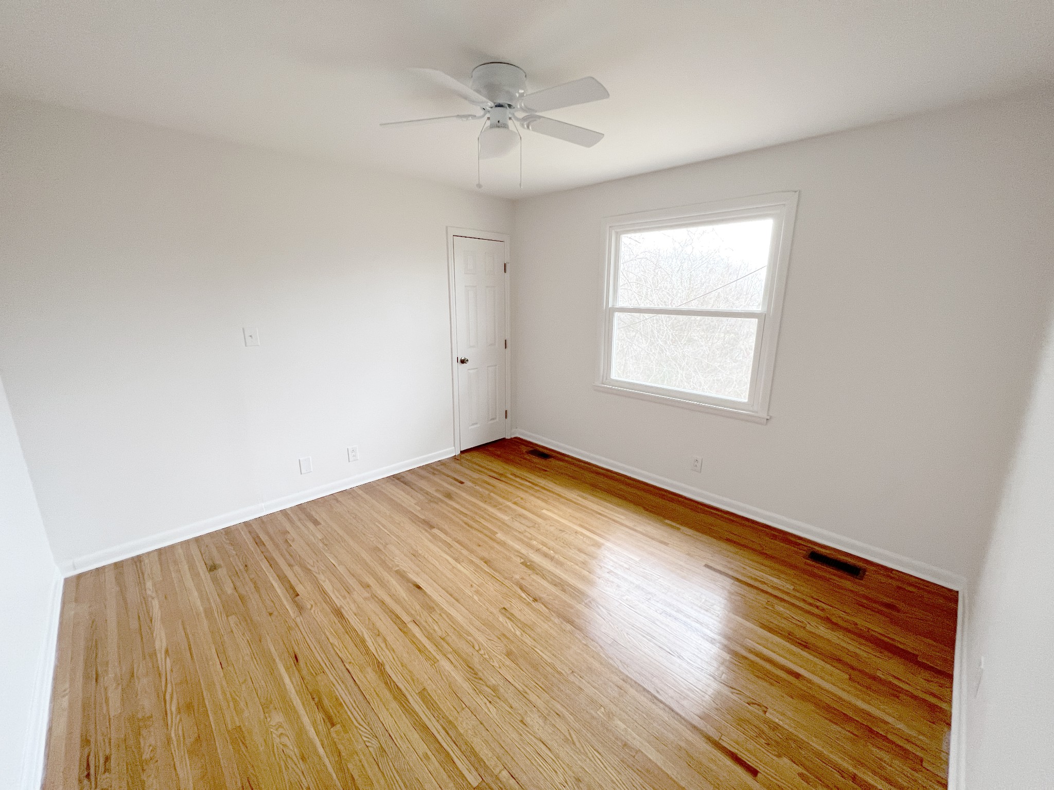 505 High Point Road Clarksville, TN 37042 - Photo 32 of 39 an empty room with wooden floor and windows
