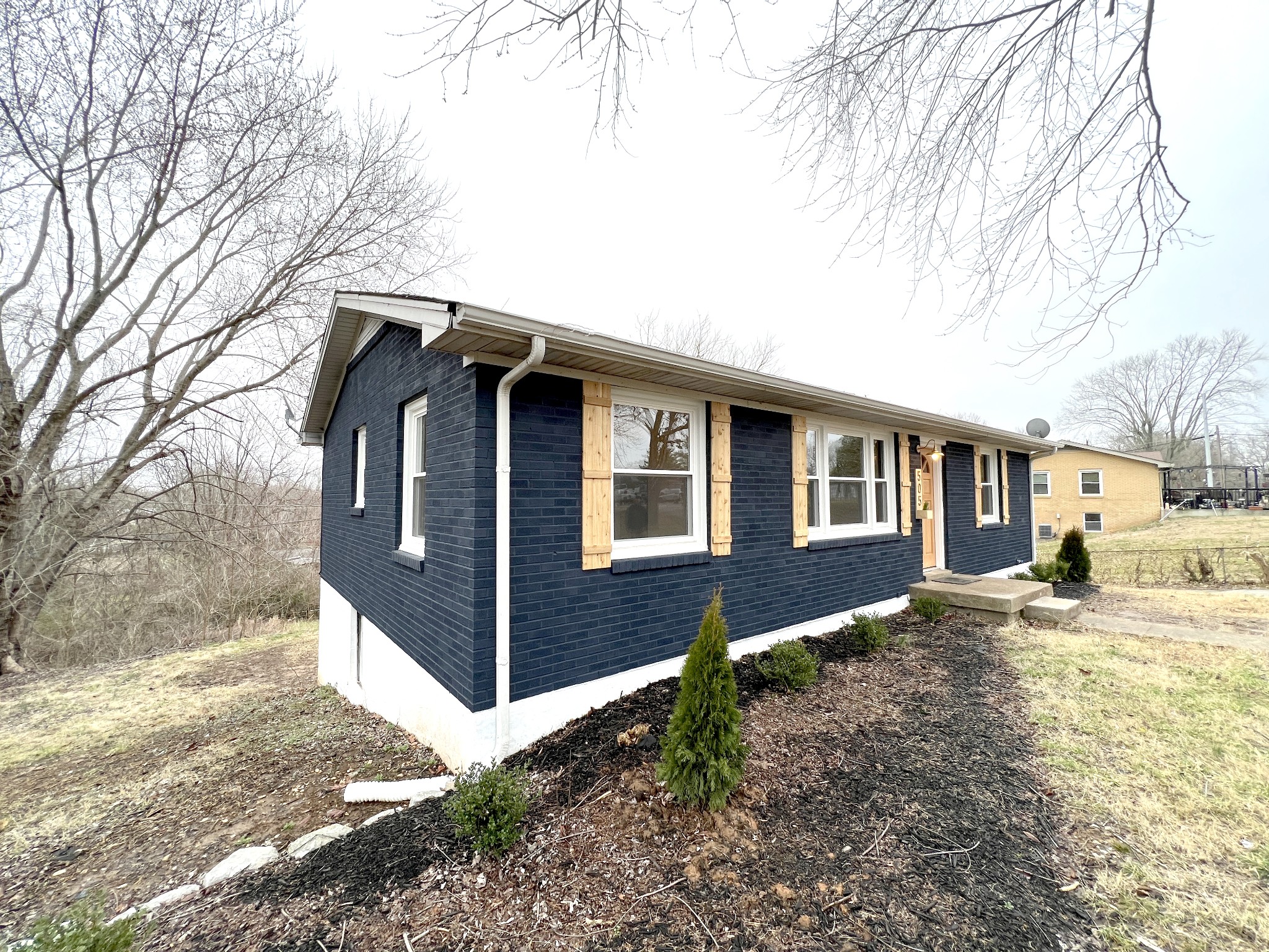 505 High Point Road Clarksville, TN 37042 - Photo 6 of 39 a front view of a house with a yard covered in snow