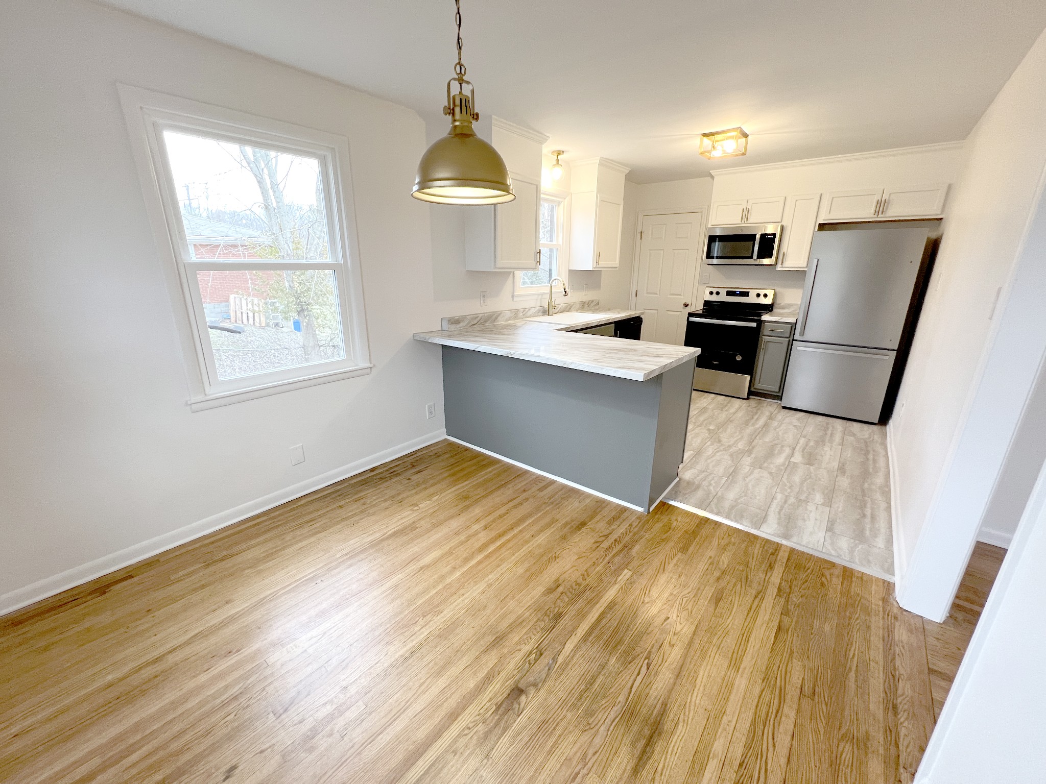 505 High Point Road Clarksville, TN 37042 - Photo 10 of 39 a kitchen with stainless steel appliances a refrigerator sink and wooden floor