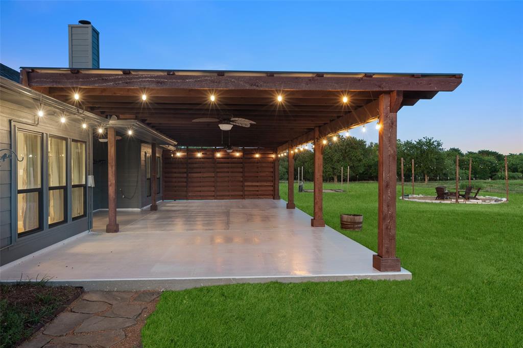 1019 Vaughan Lane Tioga, TX 76271 - Photo 32 of 40 Expansive covered patio with exposed wood beams and string lighting