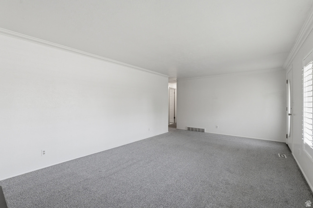 148 Tennyson Avenue Sandy, UT 84070 - Photo 6 of 55 Spacious room featuring light gray carpeting, white walls, and crown molding