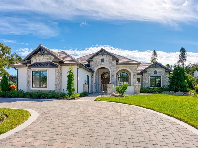 an aerial view of residential houses with outdoor space and lake view