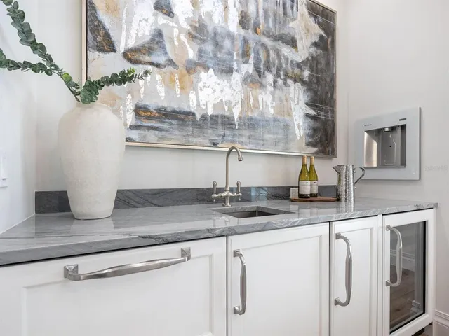 a bathroom with a granite countertop sink a toilet and a mirror