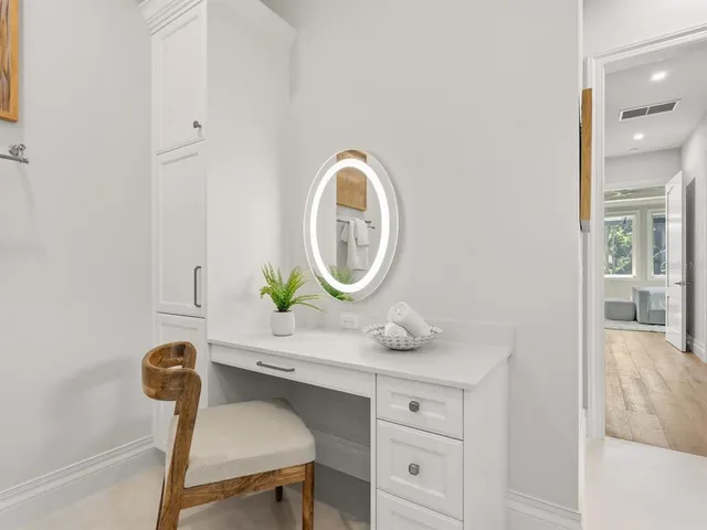 an aerial view of residential houses with outdoor space and lake view