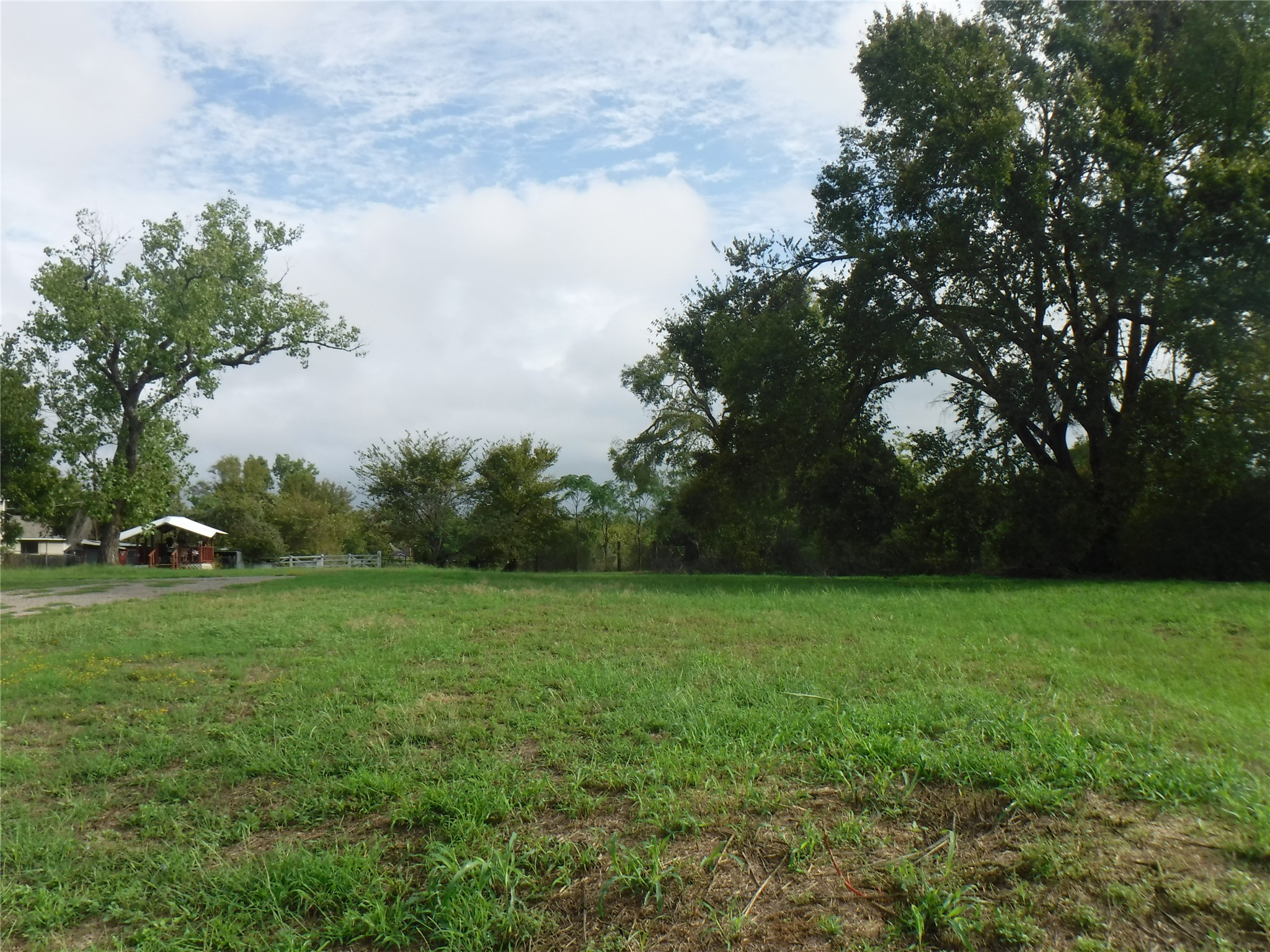 524 Old McDade Road Elgin, TX 78621 - Photo 2 of 9 Expansive green space featuring scattered mature trees and open sky