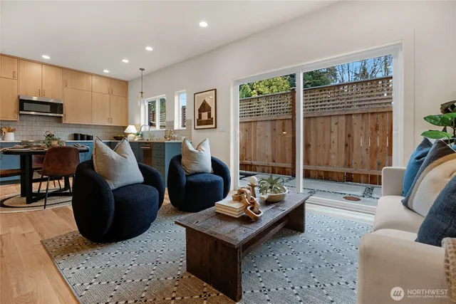 a living room with furniture a rug and a large window