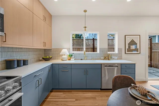 a kitchen with stainless steel appliances granite countertop a stove sink and cabinets
