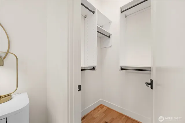a bathroom with a granite countertop sink a toilet and a window
