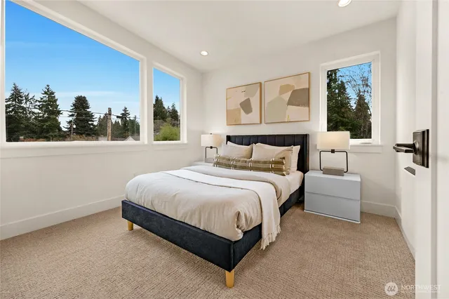 a bathroom with a granite countertop sink a toilet a mirror and shower