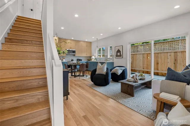 a living room with furniture and a floor to ceiling window