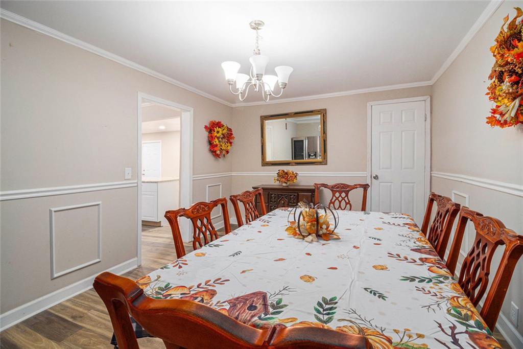 128 Highland Drive West Point, GA 31833 - Photo 11 of 22 a bedroom with a bed and a chandelier