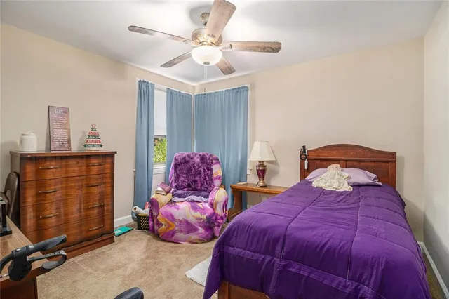 a bedroom with two beds and a chandelier