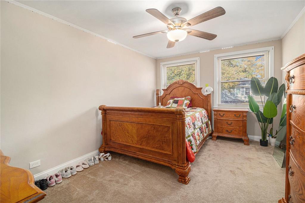 128 Highland Drive West Point, GA 31833 - Photo 14 of 22 a bedroom with a bed and a chandelier