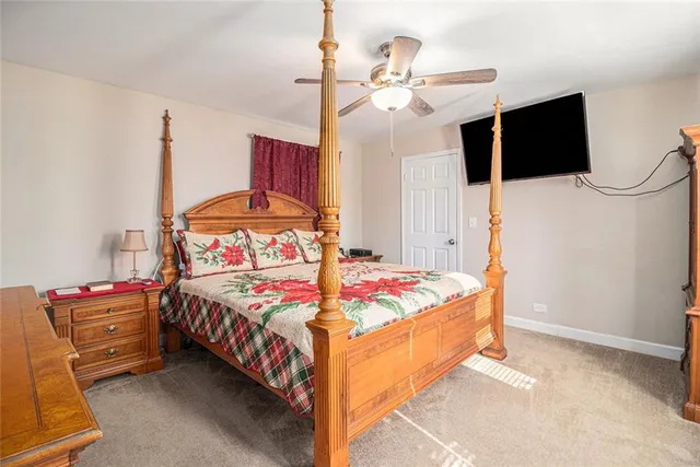 a bedroom with bed and flat tv