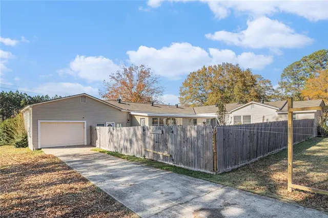 a view of a house with wooden fence
