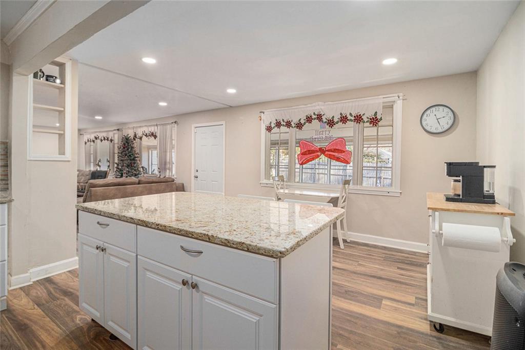 128 Highland Drive West Point, GA 31833 - Photo 9 of 22 a kitchen with granite countertop kitchen island stainless steel appliances a sink and wooden floor