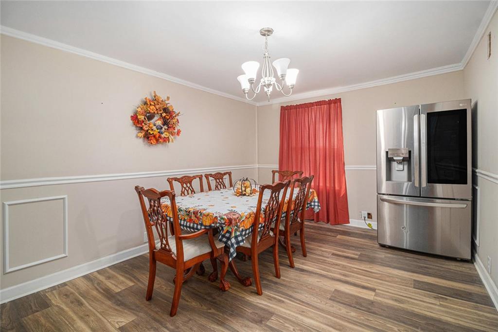 128 Highland Drive West Point, GA 31833 - Photo 10 of 22 a view of a dining room with furniture wooden floor and chandelier