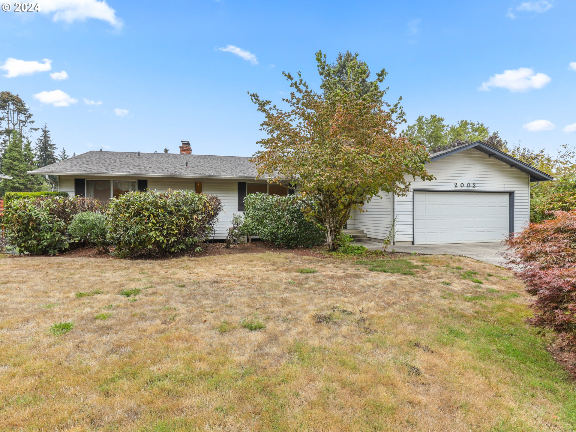 2002 Northwest 127th Street Vancouver, WA 98685 - Photo 1 of 33 a house with trees in front of it