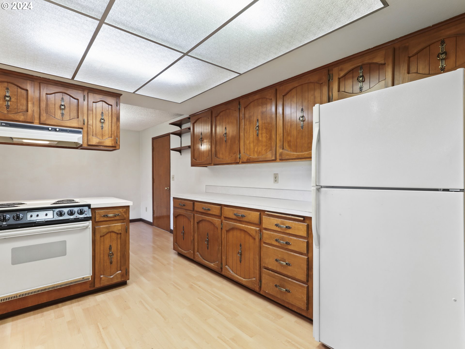 2002 Northwest 127th Street Vancouver, WA 98685 - Photo 12 of 33 a kitchen with stainless steel appliances granite countertop a refrigerator a stove and a sink with wooden cabinets
